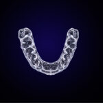 Aerial view of a clear aligners on a navy blue background