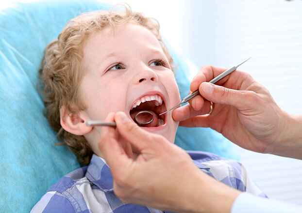 young boy undergoing a dental examination